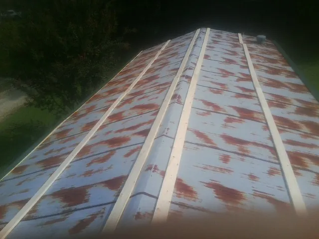 Rusted metal roof panels with new wood purlins before replacement — Storm Damage Roof Repair in Shandaken by Roofing Brothers