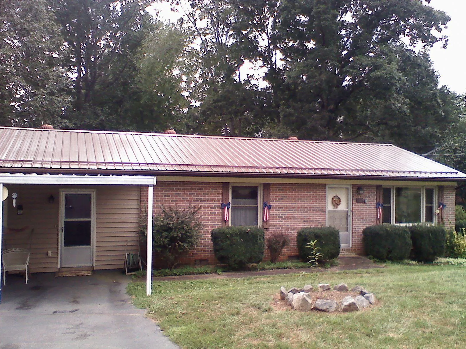 Bronze metal roof and carport on a brick ranch home — Roof Repair work by our crew in Shandaken